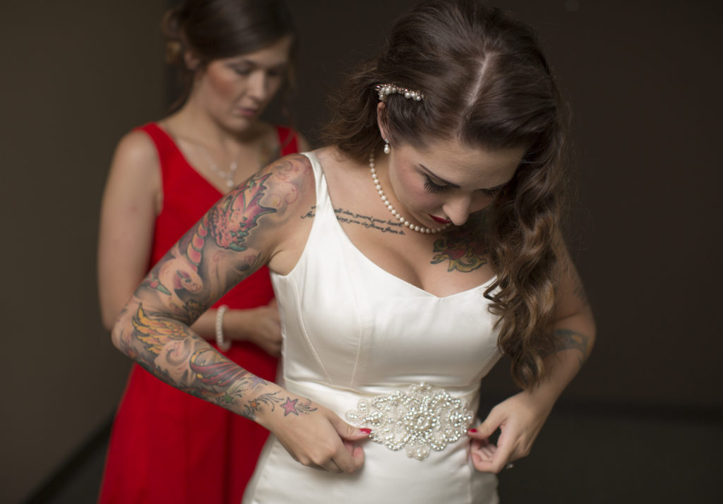 getting ready photos of the bride in centennial airport hangar