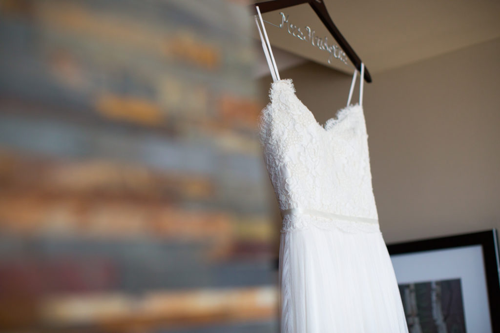 white wedding dress hanging for getting ready photo in four seasons hotel denver