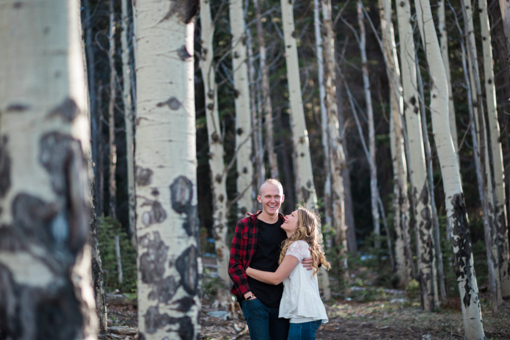 evergreen colorado engagement session in aspen grove couple snuggles