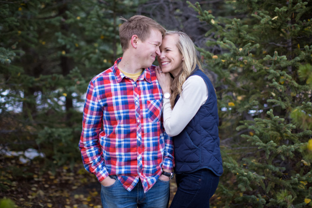 evergreen colorado engagement session sweet couples snuggles up and looks into each other