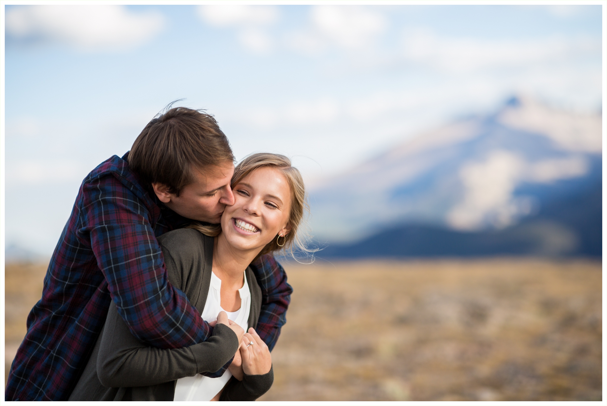 RMNP engagement session photos on Trail Ridge Road. Forest Canyon Overlook couple snuggles