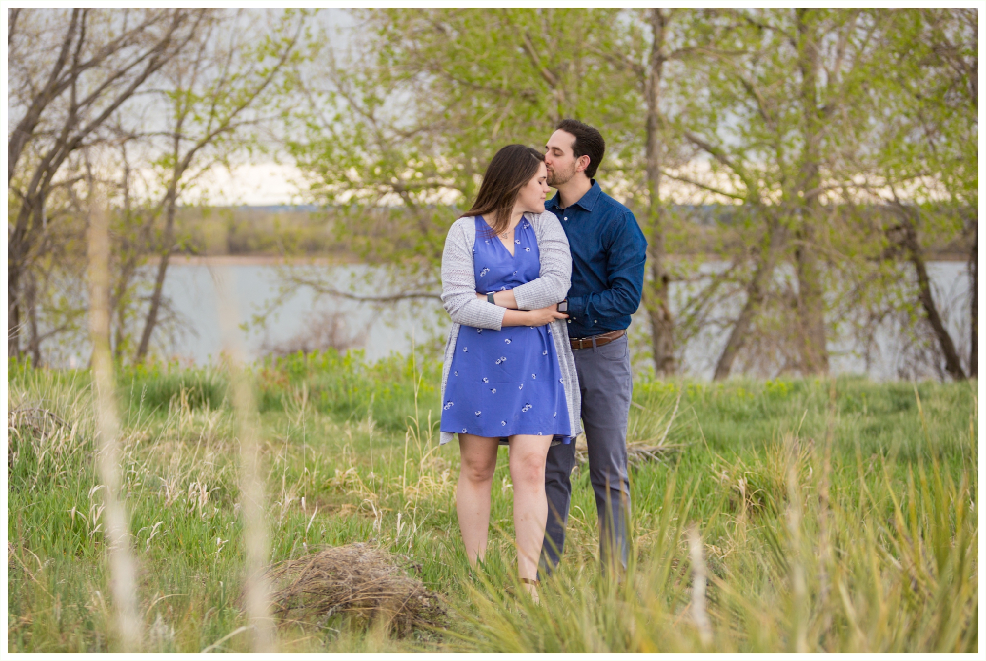 denver engagement photographer shoots spring Colorado session at Cherry Creek Reservoir. Foggy springy engagement session by Colorado engagement photographer Kathryn Kim. couple wears blue and grey engagement outfits. couple is very natural and candid, capturing authentic moments. .