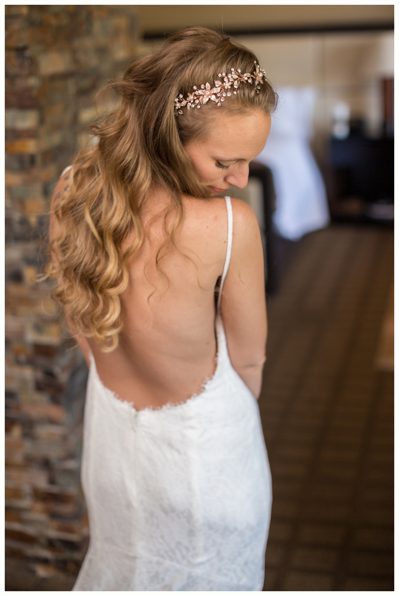 bride getting ready at blackhawk casino hotel for panorama point elopement. beautiful backless wedding dress
