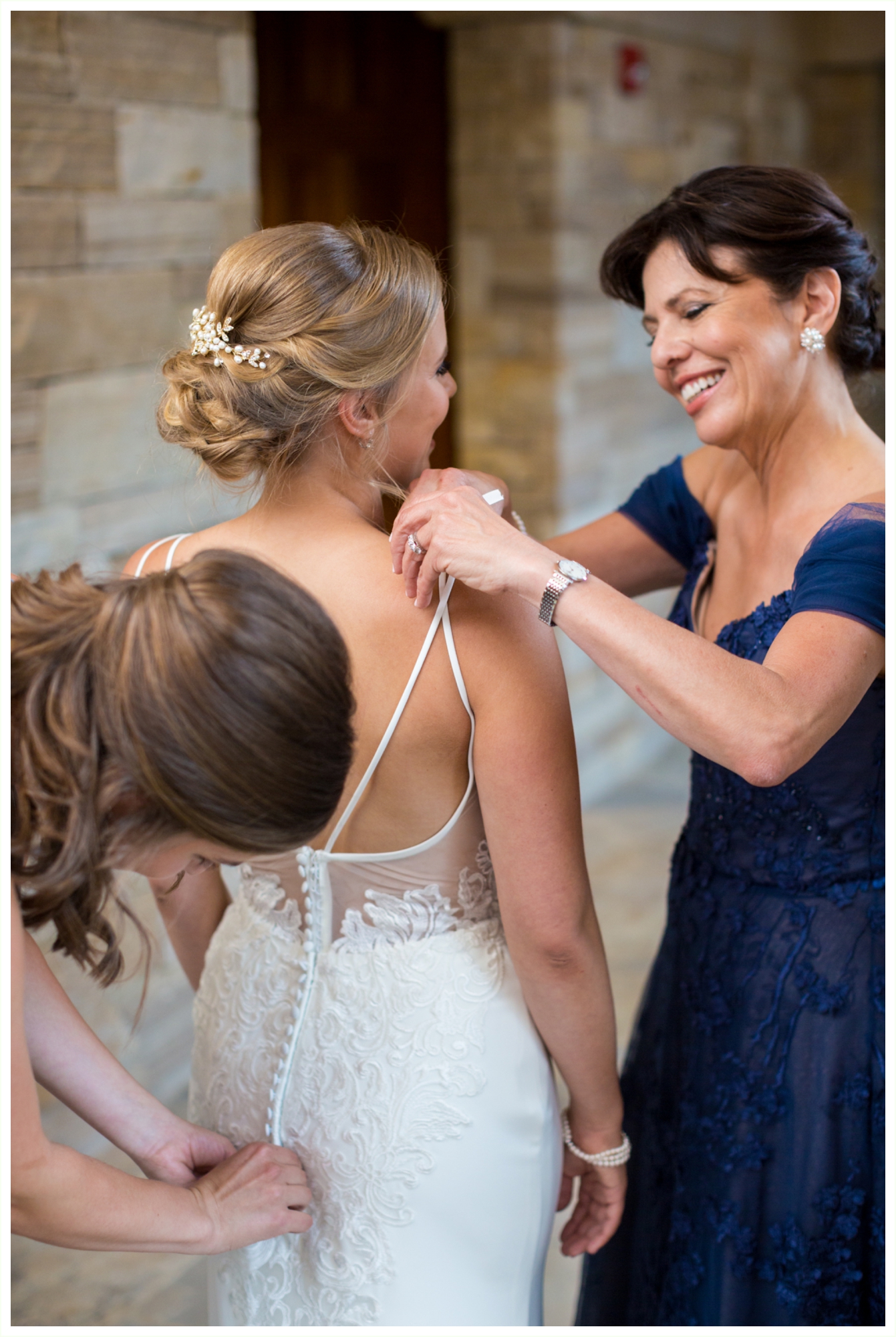 bride and her mom sharing sweet moments while bride gets into wedding dress at sanctuary golf course