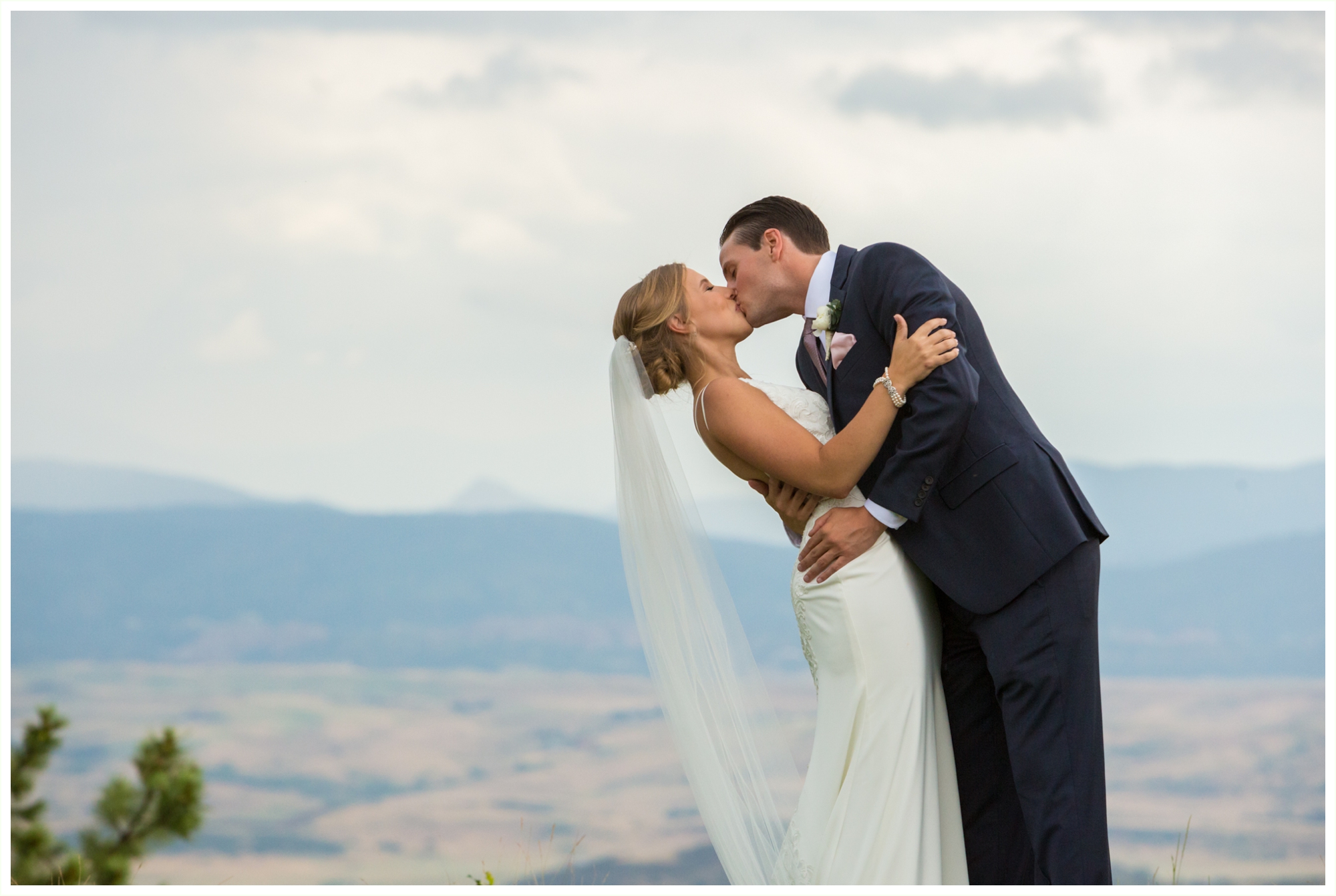 bride and groom share a kiss on golf course at wedding venue in colorado
