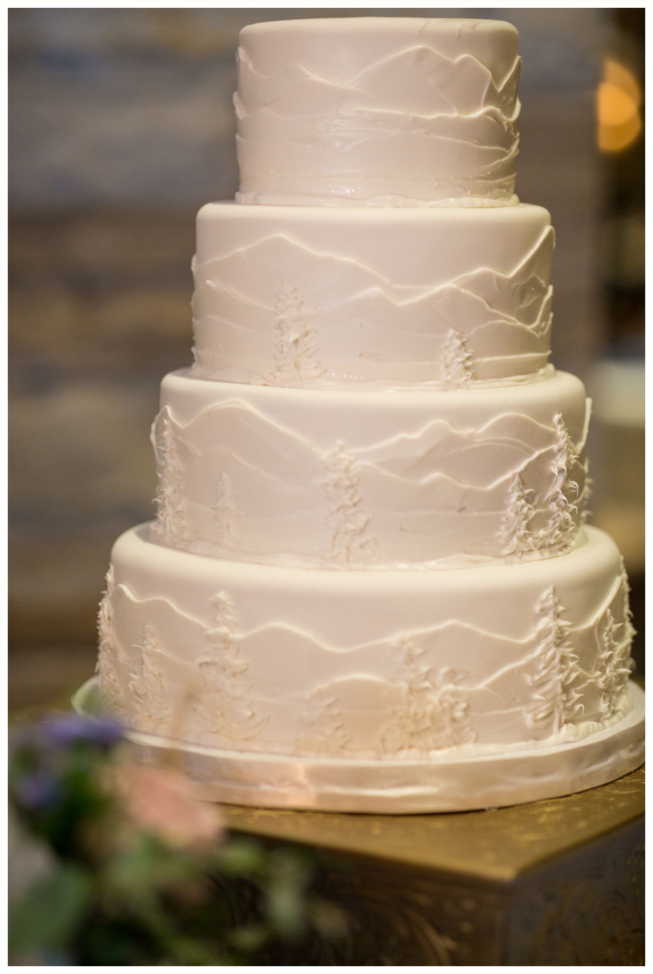 beautiful wedding cake with colorado mountain and tree details