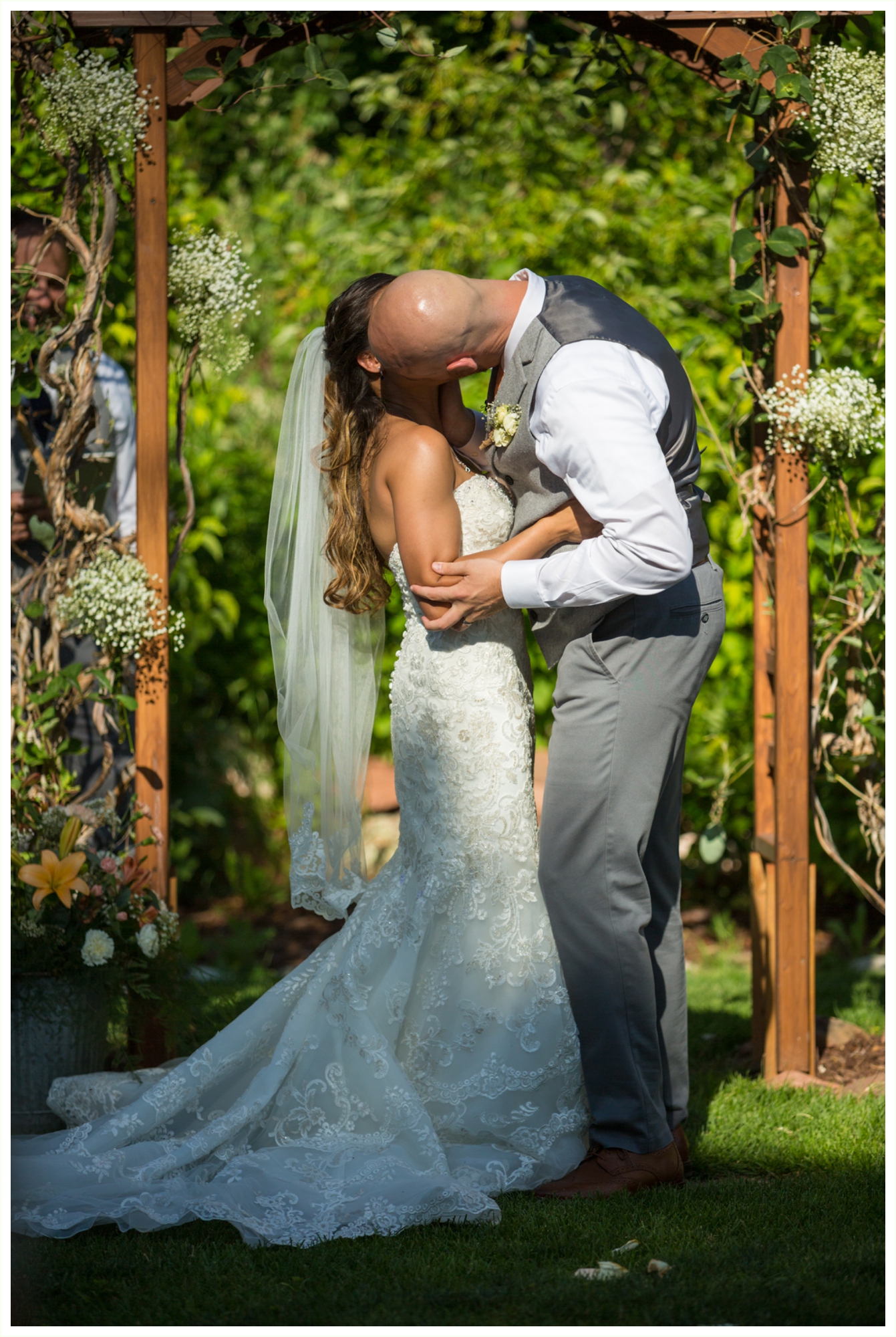 bride and groom share first kiss after wedding ceremony