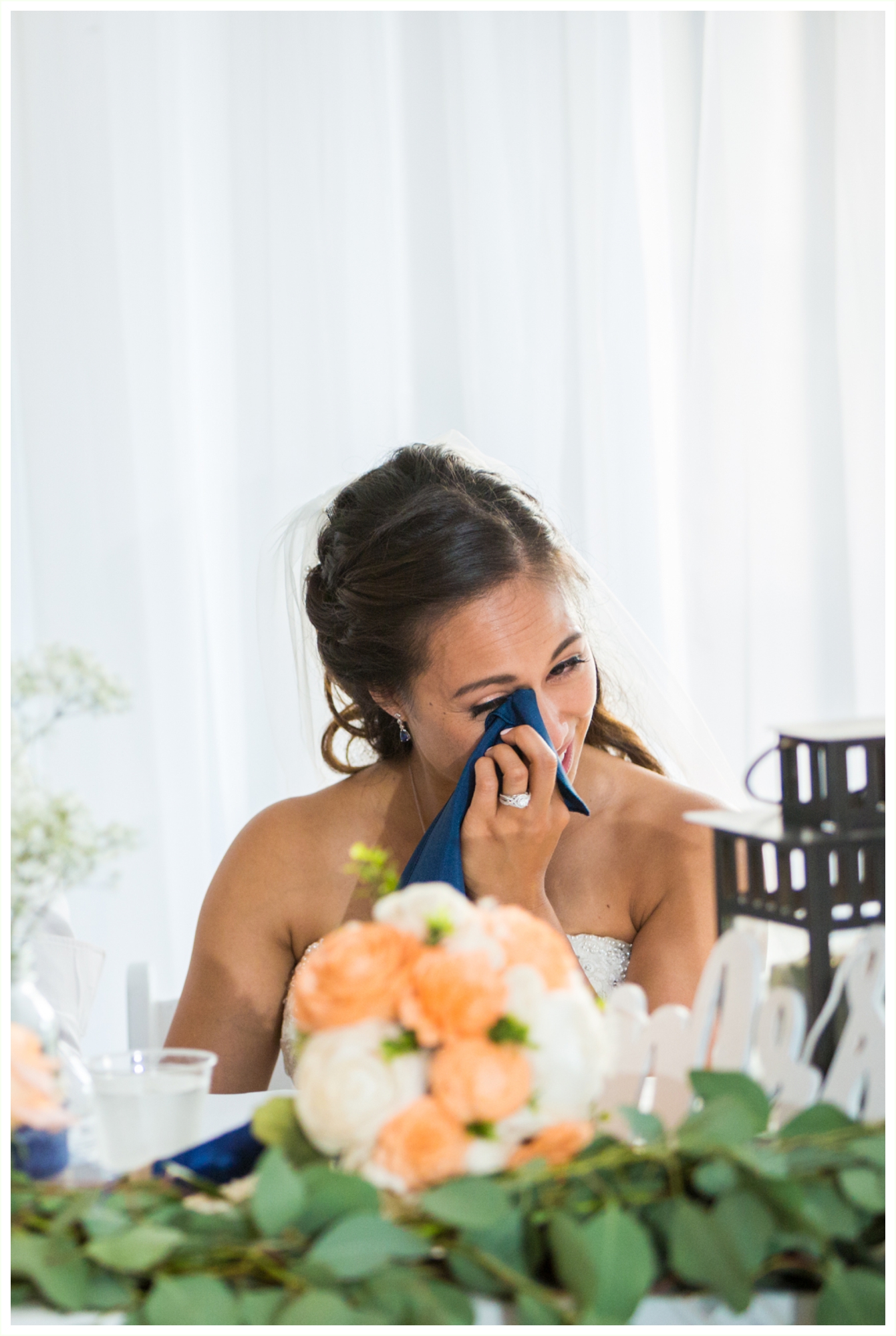 bride gets emotional during toasts at wedding reception