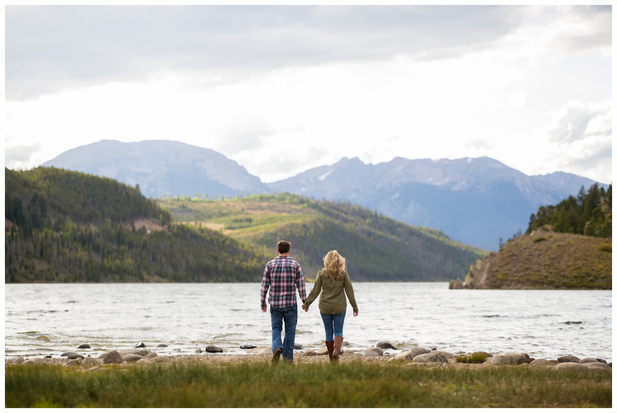 couple holding hands walking towards Lake Dillon