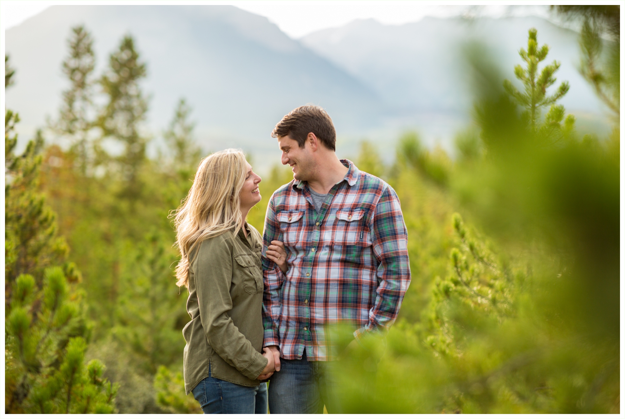 couple photos in front of lake dillon during fall colorado engagement session guy wearing plaid button down