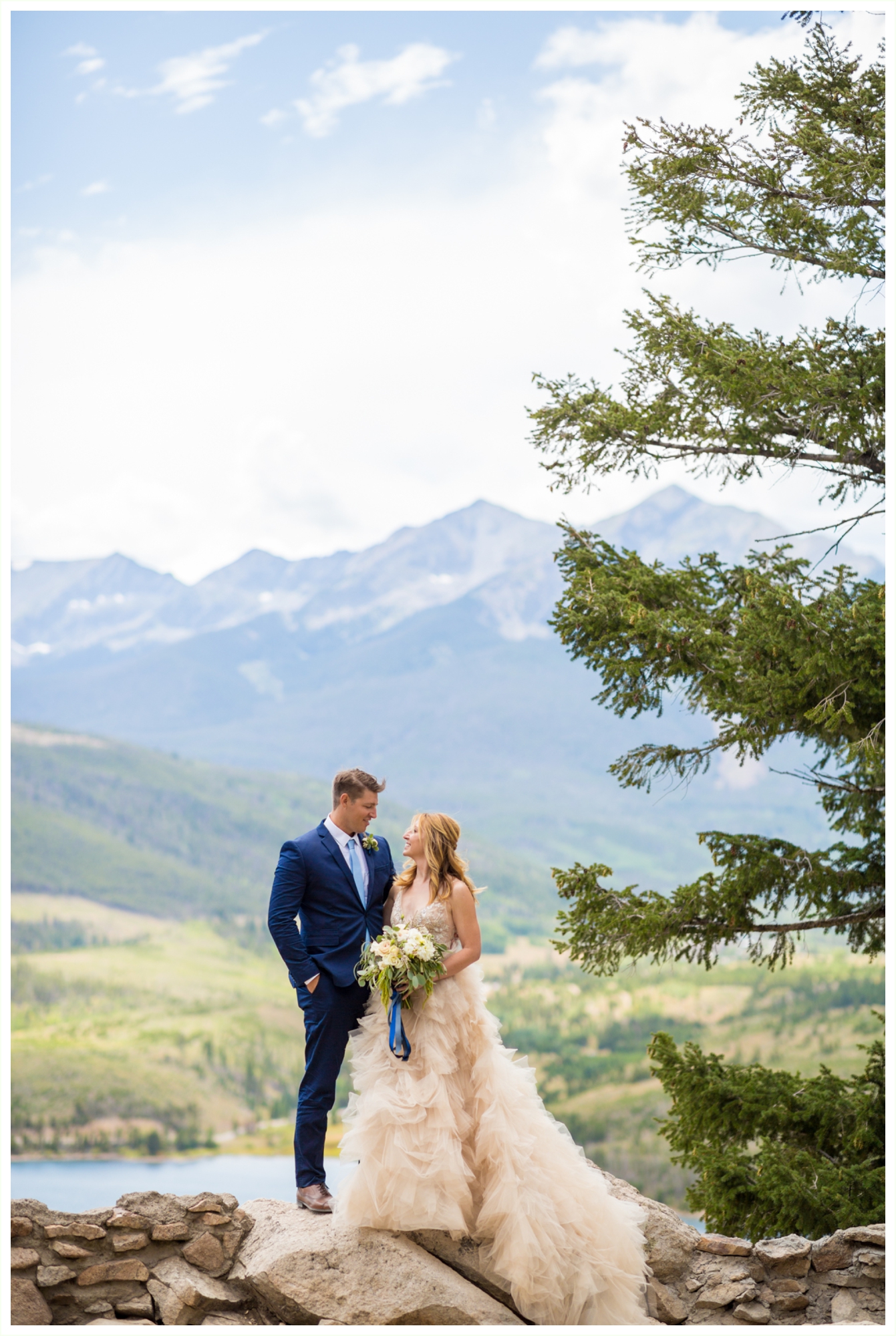 bride and groom portraits at sapphire point overlook in breckenridge at lake dillon