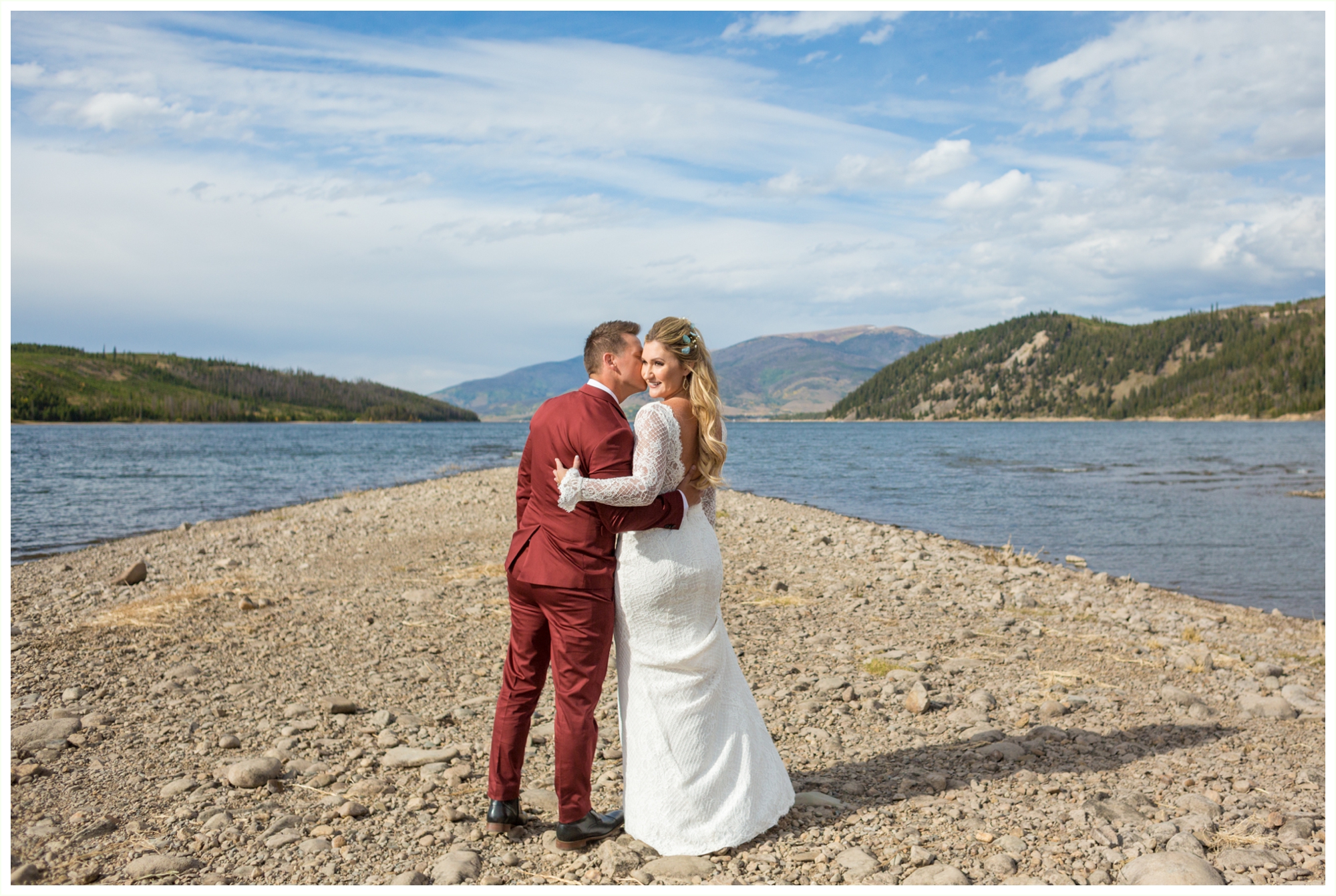 bride and groom photos at lake dillon before sapphire point elopement groom wears maroon suit bride has long sleeved dress