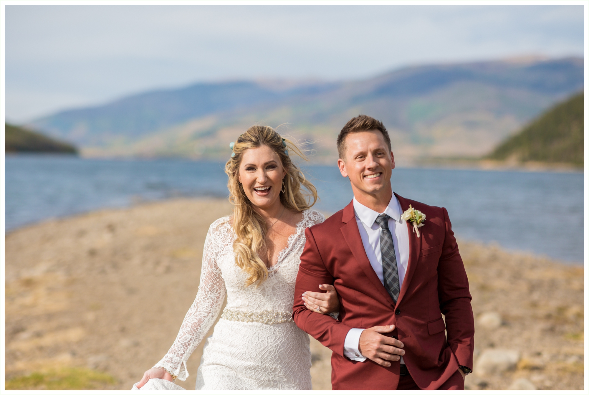 bride and groom photos at lake dillon before sapphire point elopement groom wears maroon suit bride has long sleeved dress walking candid photos